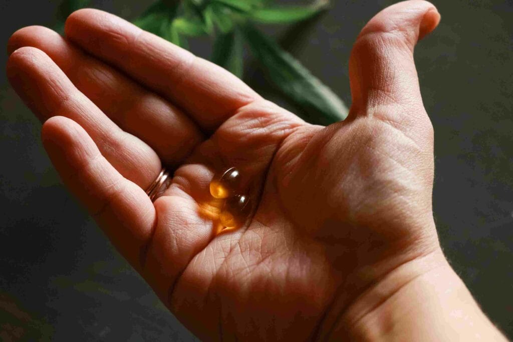 Two Cannabinol capsules in the palm of a hand