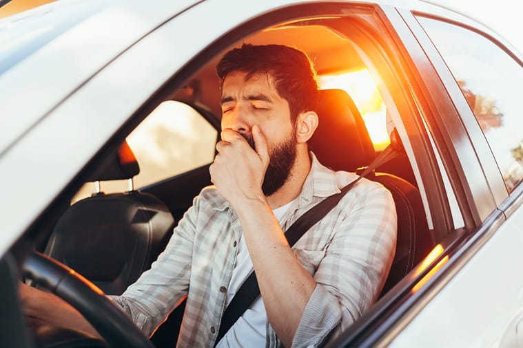 Man feeling drowsy while driving.