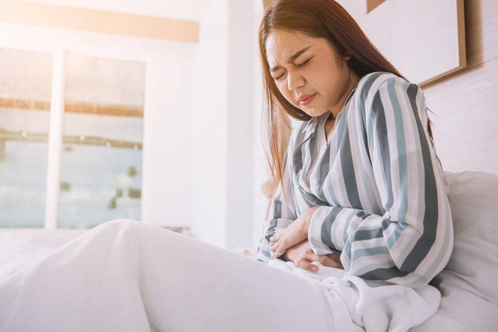 Woman with pain representing possible CBD effects.